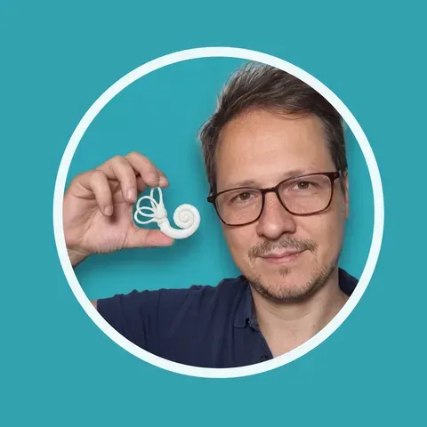 Elie Tragiannides, physiotherapist and instructor at Physio Learning, holding a 3D-printed model of the inner ear